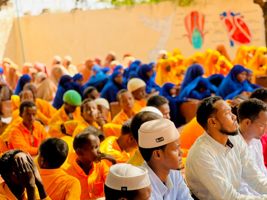 A large community gathering in a bright hall